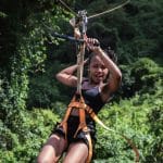 A woman on a zip line in the jungle